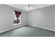 Bedroom with green carpet, light blue walls and window at 1424 Figueroa St, The Villages, FL 32162