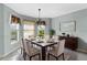 Elegant dining room featuring neutral wall paint and a large square table for six at 1424 Figueroa St, The Villages, FL 32162