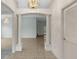 Grand foyer with decorative columns, tiled floors, and a chandelier fixture at 1424 Figueroa St, The Villages, FL 32162