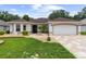 Beautiful home with landscaped front yard, decorative rock features, and a paved driveway at 1424 Figueroa St, The Villages, FL 32162