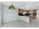 Open kitchen with wood cabinets, granite countertops, and a breakfast bar at 1424 Figueroa St, The Villages, FL 32162