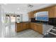 Kitchen with granite countertops, oak cabinets, and stainless steel appliances at 1424 Figueroa St, The Villages, FL 32162