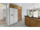 Kitchen showcasing a large refrigerator, oak cabinetry, and granite countertops at 1424 Figueroa St, The Villages, FL 32162