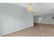 Spacious living room featuring tile floors and a decorative chandelier at 1424 Figueroa St, The Villages, FL 32162