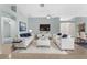 Comfortable living room featuring white sofas, blue pillows, and modern decor at 1424 Figueroa St, The Villages, FL 32162