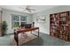 Bright office features a modern desk, large window, and custom wooden bookshelf at 1424 Figueroa St, The Villages, FL 32162