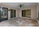 Outdoor patio with decorative stone floor and multiple sliding glass doors at 1424 Figueroa St, The Villages, FL 32162