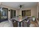 Outdoor patio with decorative stone floor and a dining table with seating at 1424 Figueroa St, The Villages, FL 32162
