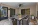 Inviting screened porch with a ceiling fan, dining table, and comfortable wicker chairs at 1424 Figueroa St, The Villages, FL 32162