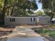 Classic home featuring a manicured lawn, neutral siding, and welcoming front entrance at 3346 Se 131St Pl, Belleview, FL 34420