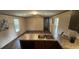 Open floor plan reveals a modern kitchen with stainless steel appliances and ample counter space at 3346 Se 131St Pl, Belleview, FL 34420