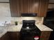 Well-equipped kitchen featuring a modern stove and granite countertops at 3346 Se 131St Pl, Belleview, FL 34420
