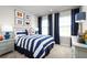 Cozy bedroom with nautical-themed decor, comfortable bed, and natural light, perfect for relaxation at 454 Hammock Oaks Blvd, Lady Lake, FL 32159