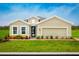 Charming single-Gathering home with manicured lawn, colorful flowerbed, and two-car garage, perfect curb appeal at 454 Hammock Oaks Blvd, Lady Lake, FL 32159
