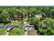 An aerial perspective captures a home with solar panels, fenced yard, detached garage and landscaping, set within a green landscape at 801 Nw 16Th Ct, Ocala, FL 34475