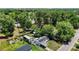 Aerial view featuring a home with solar panels, sheds, and greenery, nestled next to a cemetery at 801 Nw 16Th Ct, Ocala, FL 34475