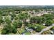 Expansive aerial view showcases the neighborhood, with tree-lined streets and the town's buildings in the background at 801 Nw 16Th Ct, Ocala, FL 34475