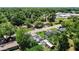 An aerial view of neighborhood homes with lush trees, street access, and well-maintained lawns at 801 Nw 16Th Ct, Ocala, FL 34475