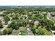 An aerial view displaying neighborhood homes amidst lush trees, streetscapes and community charm at 801 Nw 16Th Ct, Ocala, FL 34475