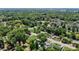 An aerial view of neighborhood homes surrounded by lush trees and landscapes, showcasing serene street access at 801 Nw 16Th Ct, Ocala, FL 34475