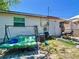 Backyard featuring a swing set, mature trees, and access to the back of the home at 801 Nw 16Th Ct, Ocala, FL 34475
