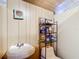 Small bathroom with toilet and sink and storage shelves at 801 Nw 16Th Ct, Ocala, FL 34475