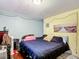 View of the bedroom with a dark-colored bed and blue walls at 801 Nw 16Th Ct, Ocala, FL 34475