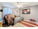 Calm bedroom with neutral walls, ceiling fan, and a large painting accenting the space at 801 Nw 16Th Ct, Ocala, FL 34475