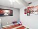 This bedroom is decorated with nature-themed art, colorful furniture, and light gray walls at 801 Nw 16Th Ct, Ocala, FL 34475