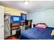 View of the bedroom with a dark-colored bed, suitcases, and a tv at 801 Nw 16Th Ct, Ocala, FL 34475