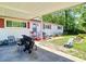 Charming single-story home with red shutters, solar panels, a carport, and fenced front yard at 801 Nw 16Th Ct, Ocala, FL 34475