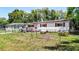 Charming single-story home with red shutters, solar panels, a carport, and fenced front yard at 801 Nw 16Th Ct, Ocala, FL 34475