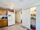 Functional kitchen with white appliances, wood cabinets, and a pantry for ample storage at 801 Nw 16Th Ct, Ocala, FL 34475