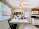 Bright eat-in kitchen with white appliances and ceiling fan, ideal for casual dining and cooking at 801 Nw 16Th Ct, Ocala, FL 34475