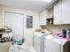 This laundry room features a washer and dryer hookups and storage cabinets at 801 Nw 16Th Ct, Ocala, FL 34475