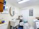 Bright laundry room featuring a utility sink, cabinetry, and washer/dryer hookups at 801 Nw 16Th Ct, Ocala, FL 34475