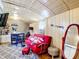 Cozy living room with a red futon, desk and chair set, and patterned rug at 801 Nw 16Th Ct, Ocala, FL 34475