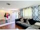 Inviting living room with stylish curtains, a sectional sofa, and wood flooring throughout at 801 Nw 16Th Ct, Ocala, FL 34475