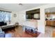 Cozy living room featuring hardwood floors, a mounted television, and access to the kitchen at 801 Nw 16Th Ct, Ocala, FL 34475