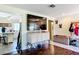 Open concept living room featuring a large TV and unique cabinet with decorative ironwork at 801 Nw 16Th Ct, Ocala, FL 34475