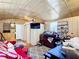 Small living room featuring a red futon, television, cabinets and an ornate rug at 801 Nw 16Th Ct, Ocala, FL 34475