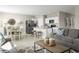 Open living space with stylish furniture, adjacent to a dining area and kitchen with neutral color palette at 1389 Laramie Way, Haines City, FL 33844