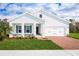 Charming single-story home featuring a brick driveway, a two car garage, and lush green lawn at 1539 Landon Ln, Haines City, FL 33844