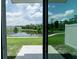 Scenic backyard view overlooking a pond and green space, accessible through sliding glass doors at 7433 Stone Creek Trl, Kissimmee, FL 34747