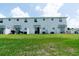 Backyard with a well-manicured lawn and patio area perfect for outdoor entertaining at 7433 Stone Creek Trl, Kissimmee, FL 34747