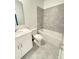 Well-lit bathroom featuring a tiled shower over the tub and modern vanity at 7433 Stone Creek Trl, Kissimmee, FL 34747