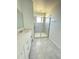 Modern bathroom features tiled walk-in shower, white cabinets, and quartz countertop at 7433 Stone Creek Trl, Kissimmee, FL 34747