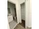 Bathroom area with a toilet, sink and storage shelves for toiletries and essentials at 7433 Stone Creek Trl, Kissimmee, FL 34747