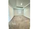 Spacious bedroom with neutral carpeting, tray ceiling, and window providing natural light at 7433 Stone Creek Trl, Kissimmee, FL 34747