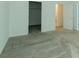 Spacious bedroom with gray carpet, white walls, and an open closet at 7433 Stone Creek Trl, Kissimmee, FL 34747